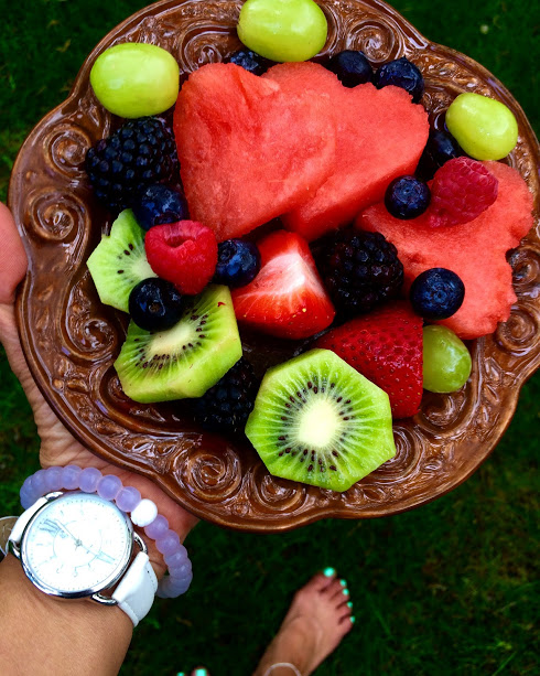 Snack of kiwi, heart shaped watermelon, grapes, raspberries, blackberries and strawberries